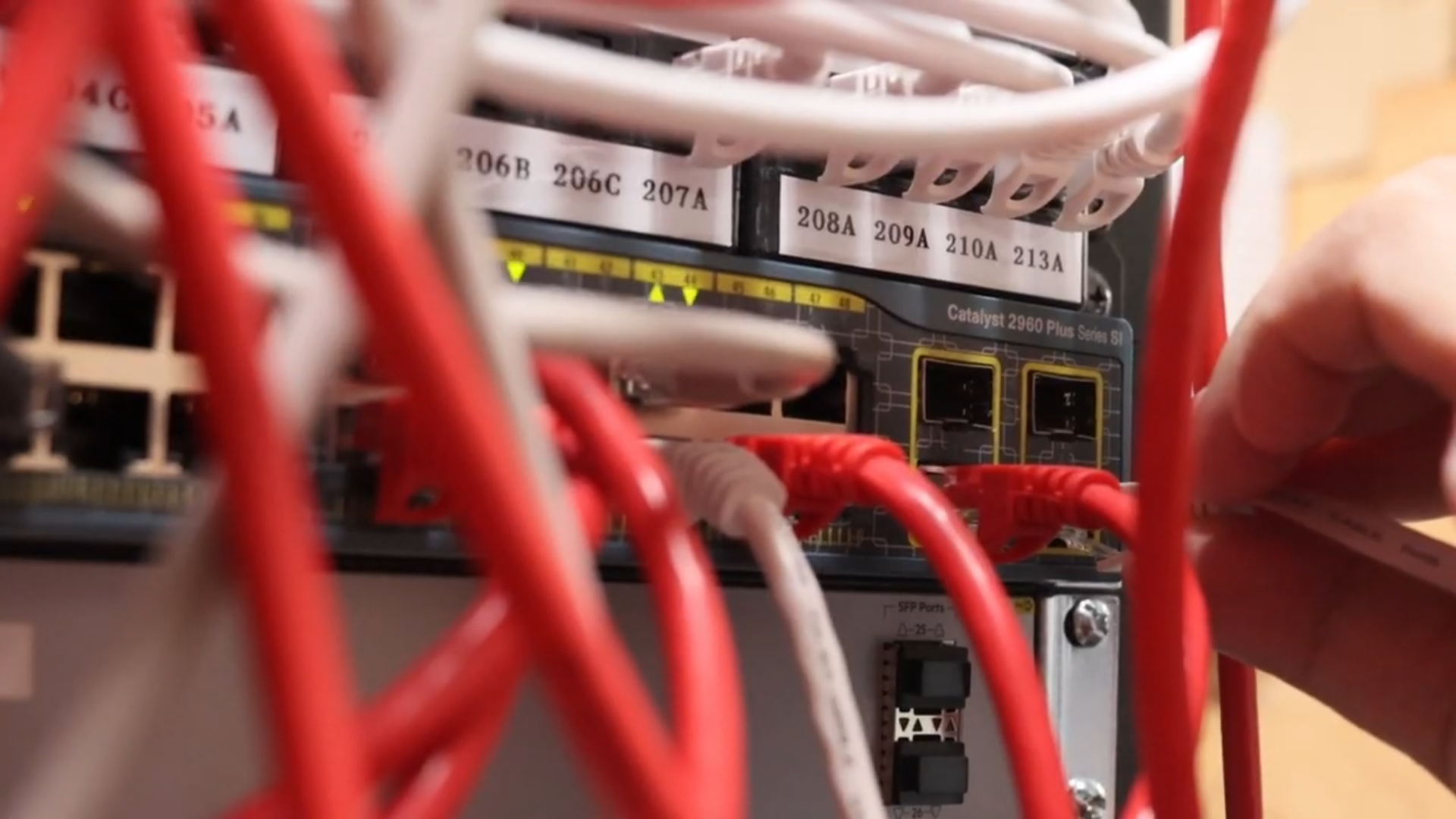 Person plugging cables to server rack